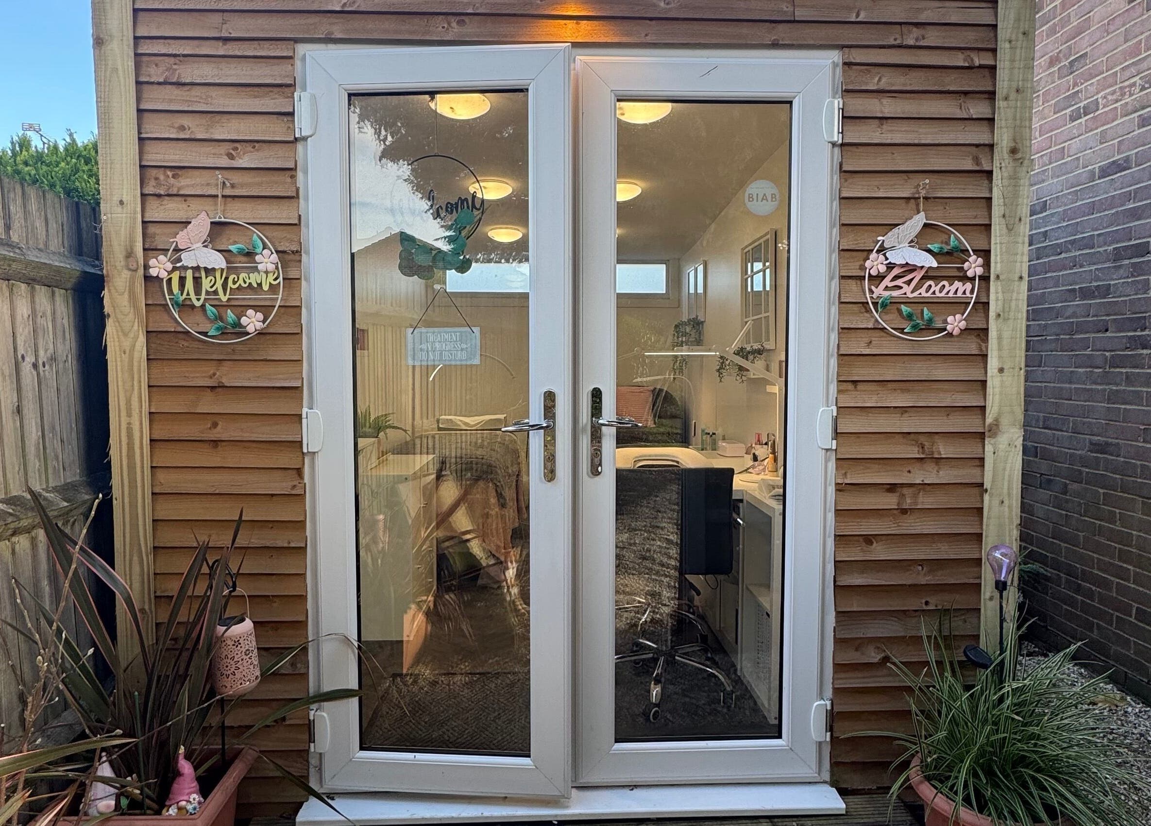 Inviting entrance of Utopia Beauty Farnham in Farnham, England, GB, with decorative signs and potted plants.