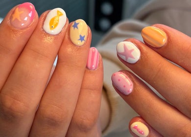 Stylish nail art at Nails by Skye, Paisley, Scotland, GB showcases vibrant star and fish designs.