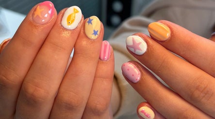 Stylish nail art at Nails by Skye, Paisley, Scotland, GB showcases vibrant star and fish designs.