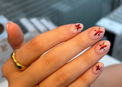 Star-themed nail art from Nails by Skye in Paisley, Scotland, GB showcasing intricate red star designs.