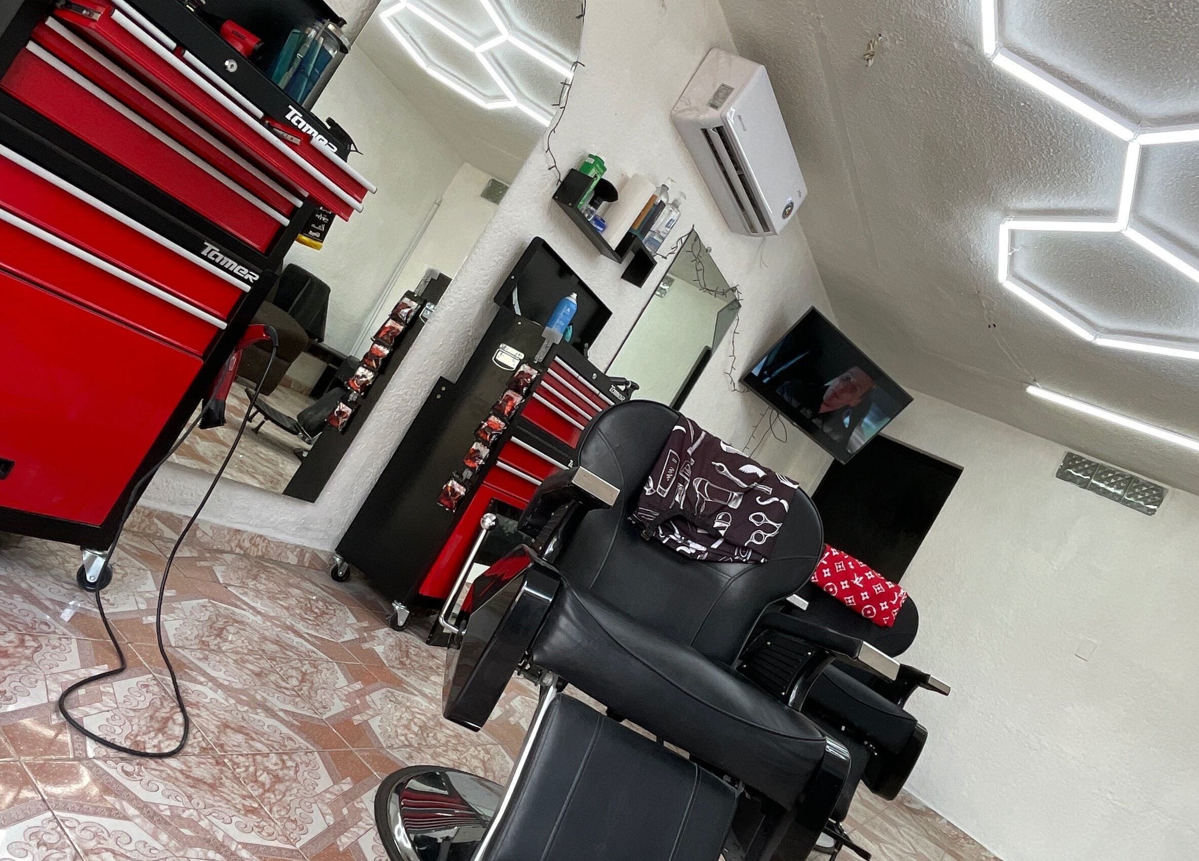 Interior de La Navaja Negra Barberia en Kanasín, Yucatán, MX. Silla negra y decoración moderna.