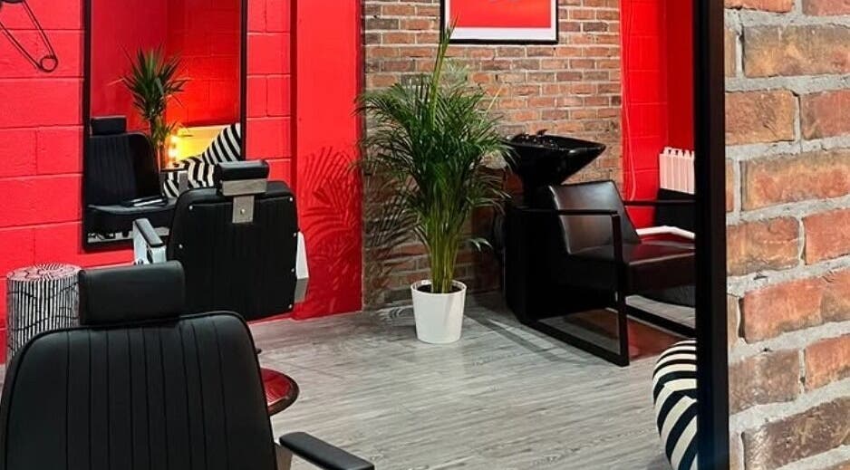 Stylish salon interior at Cult.Collective, Bristol, England, GB with red walls and modern black chairs.