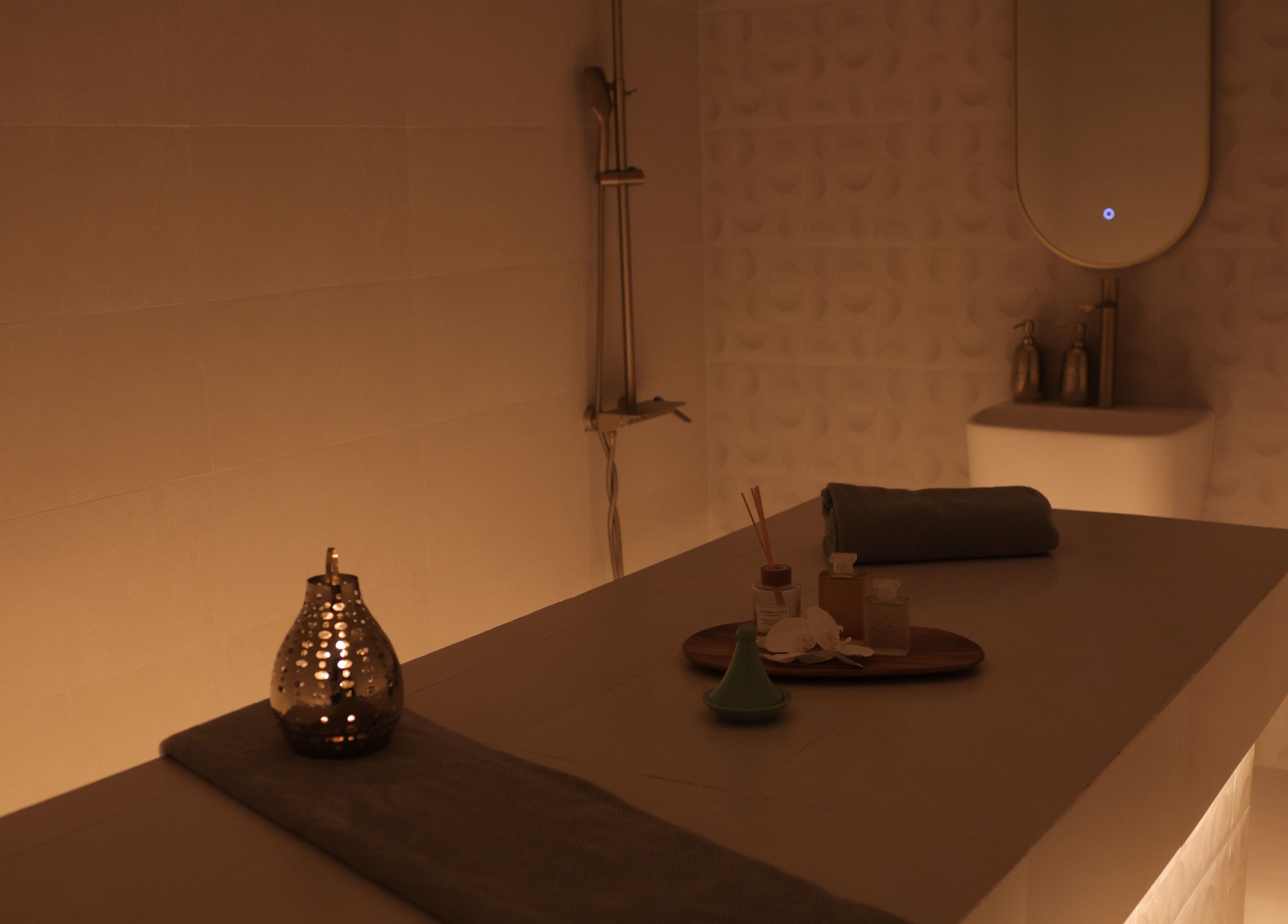 Relaxing spa room at Calm Spa, Riyadh, Riyadh Province, SA. Ambient lighting, massage table, and aromatic decor.
