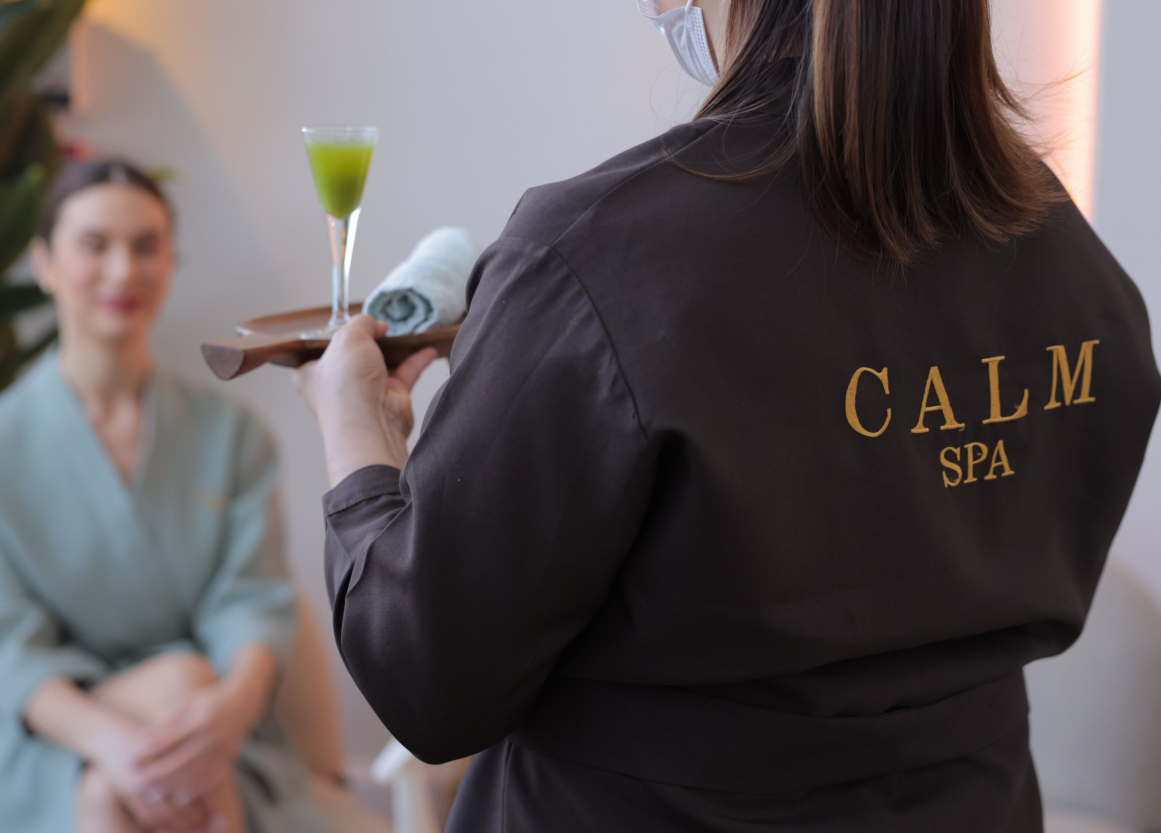 Calm Spa staff offering a refreshing drink to a customer, Riyadh, Riyadh Province, SA.