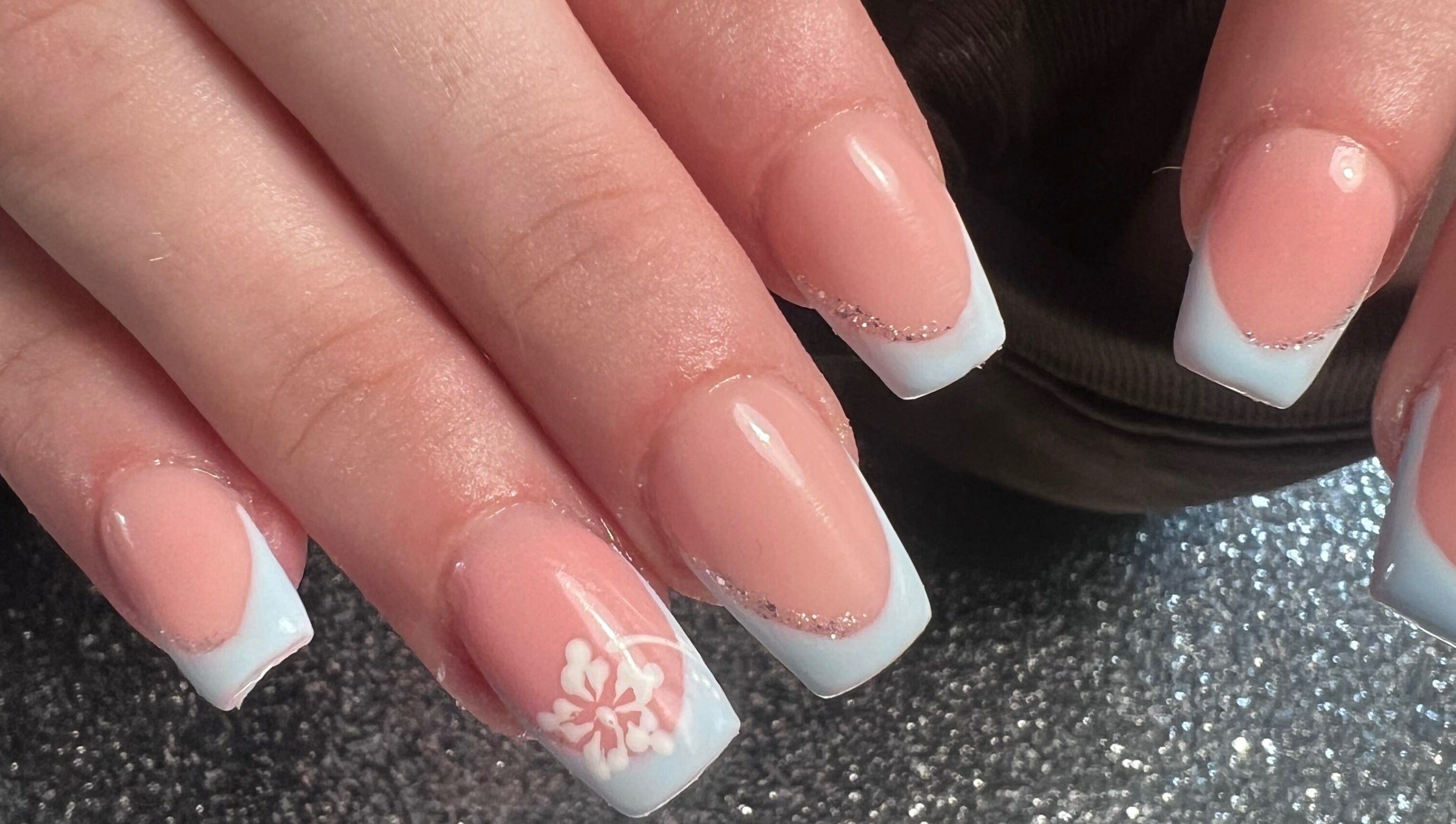 Stylish manicured hands with floral design at Glitzy Nailz Fairy, Isle Of Man, Onchan, IM.
