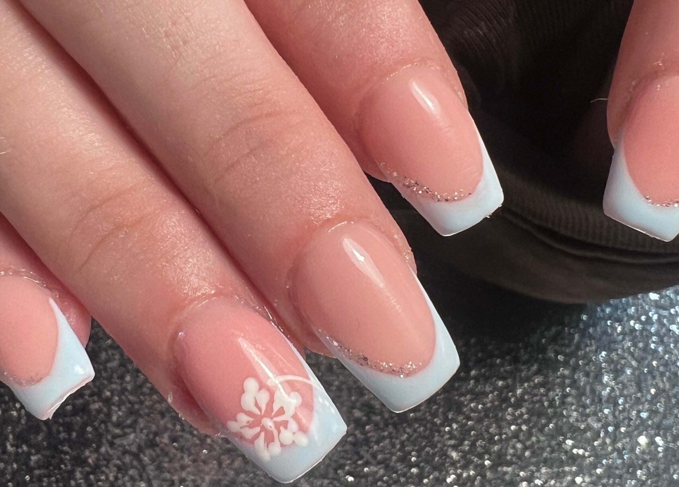 Stylish manicured hands with floral design at Glitzy Nailz Fairy, Isle Of Man, Onchan, IM.