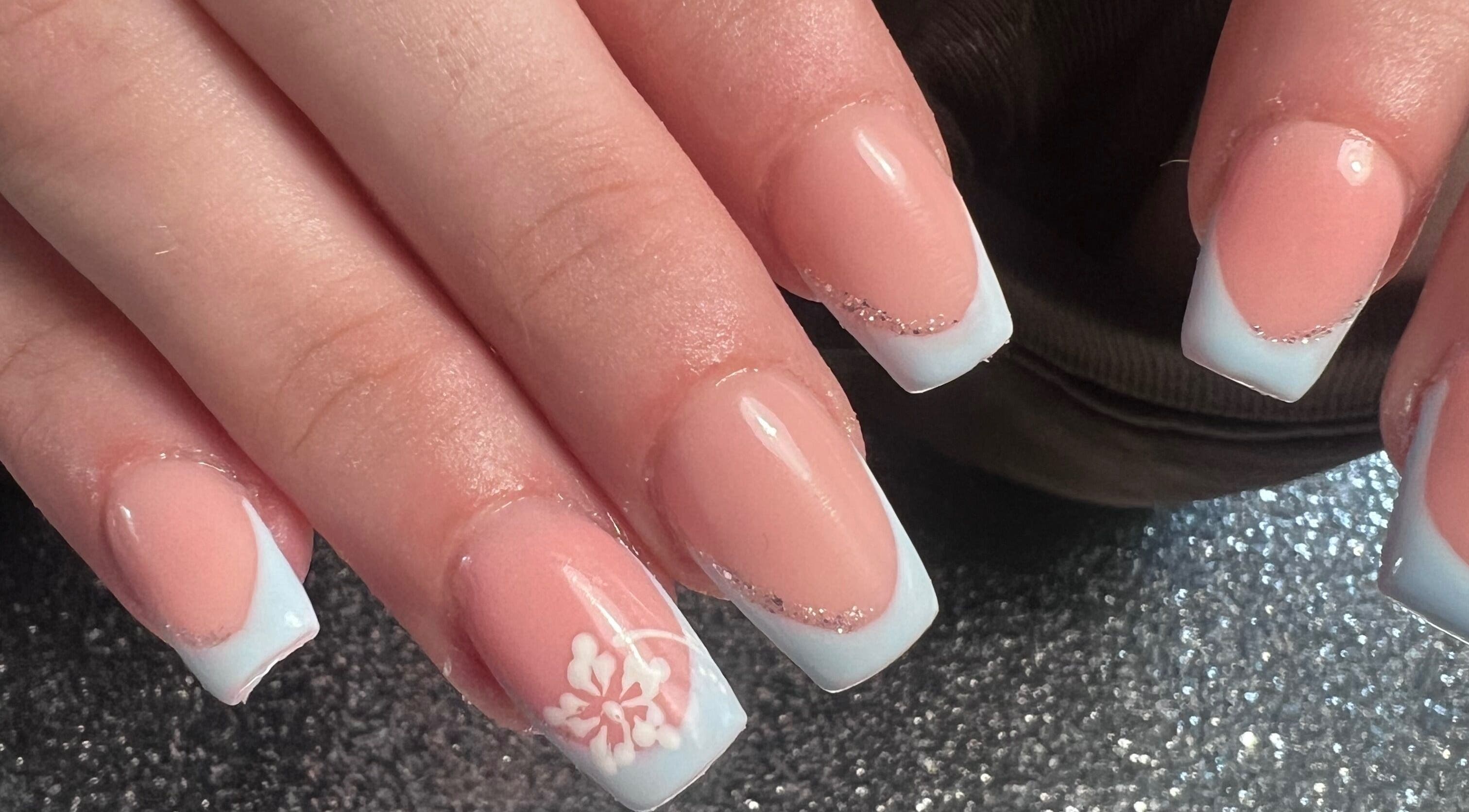 Stylish manicured hands with floral design at Glitzy Nailz Fairy, Isle Of Man, Onchan, IM.
