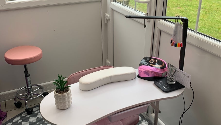 Elegant nail station at Nailsbysadie in Merthyr Tydfil, Wales, GB with pink decor and manicure tools.