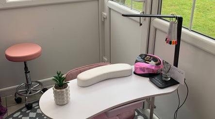 Elegant nail station at Nailsbysadie in Merthyr Tydfil, Wales, GB with pink decor and manicure tools.