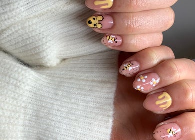 Bee-themed nail art at Nailsbysadie in Merthyr Tydfil, Wales, GB. Unique and stylish manicure design.