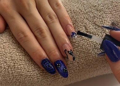 Artistic blue manicure at Nailsbysadie, Merthyr Tydfil, Wales, GB, showcasing detailed nail art.