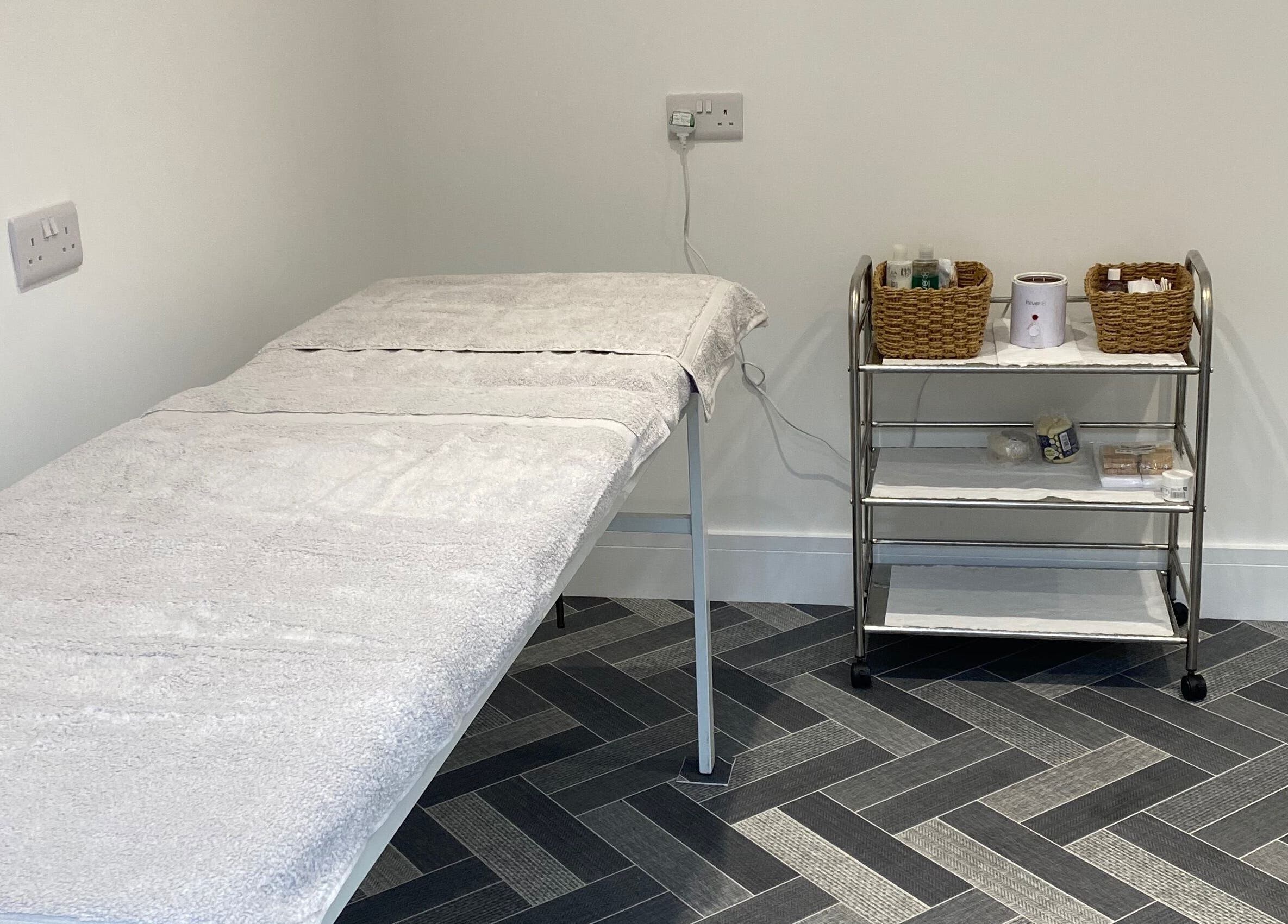 Calming treatment room at Nailsbysadie, Merthyr Tydfil, Wales, GB with massage table and essentials.