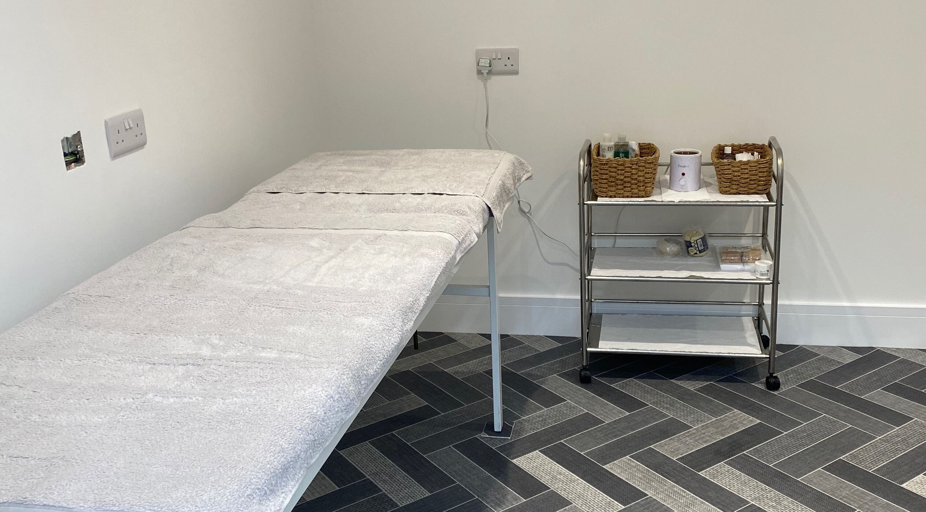 Calming treatment room at Nailsbysadie, Merthyr Tydfil, Wales, GB with massage table and essentials.