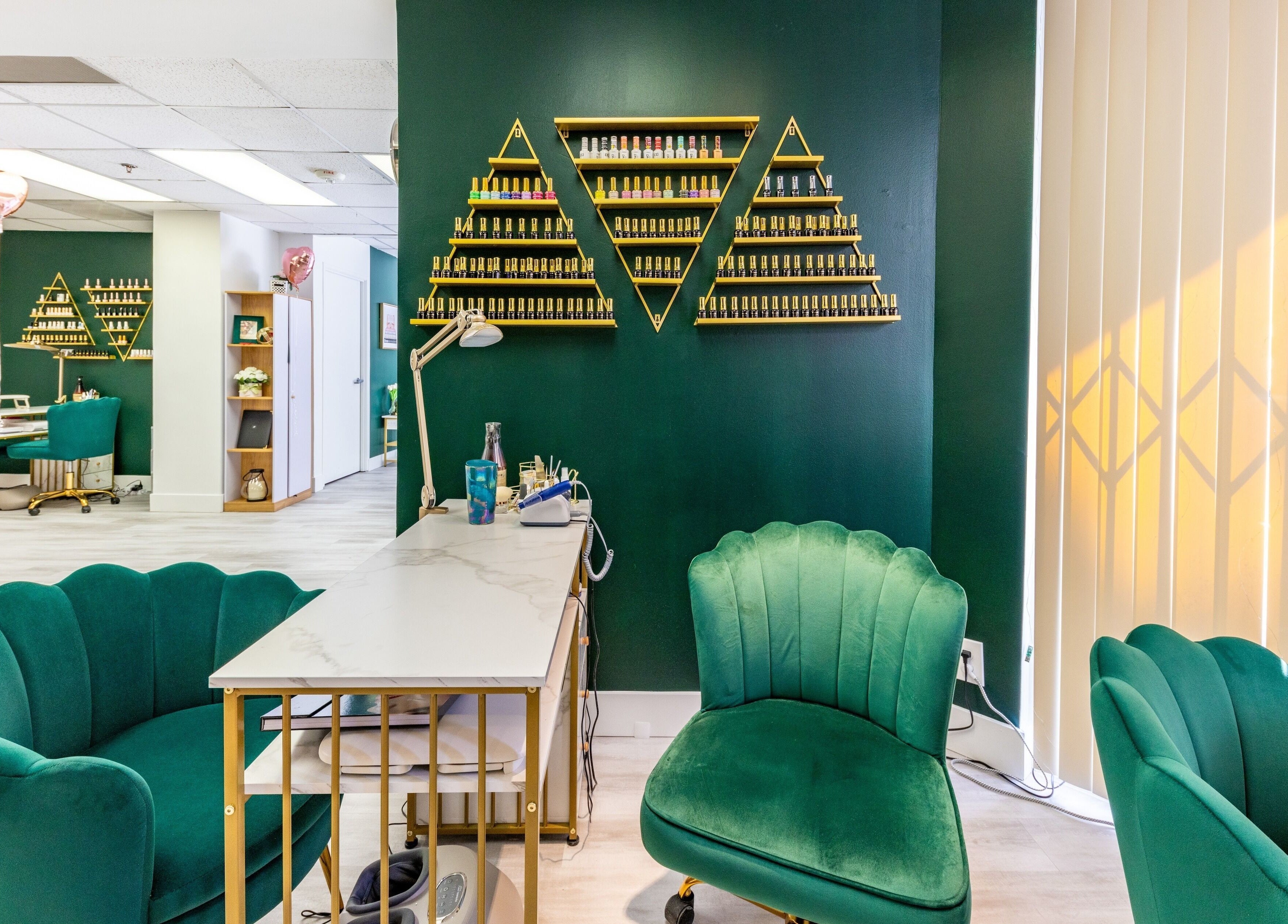 Chic interior of Yb Professional Downtown LA, featuring teal chairs and nail polish display, Los Angeles, California, US.