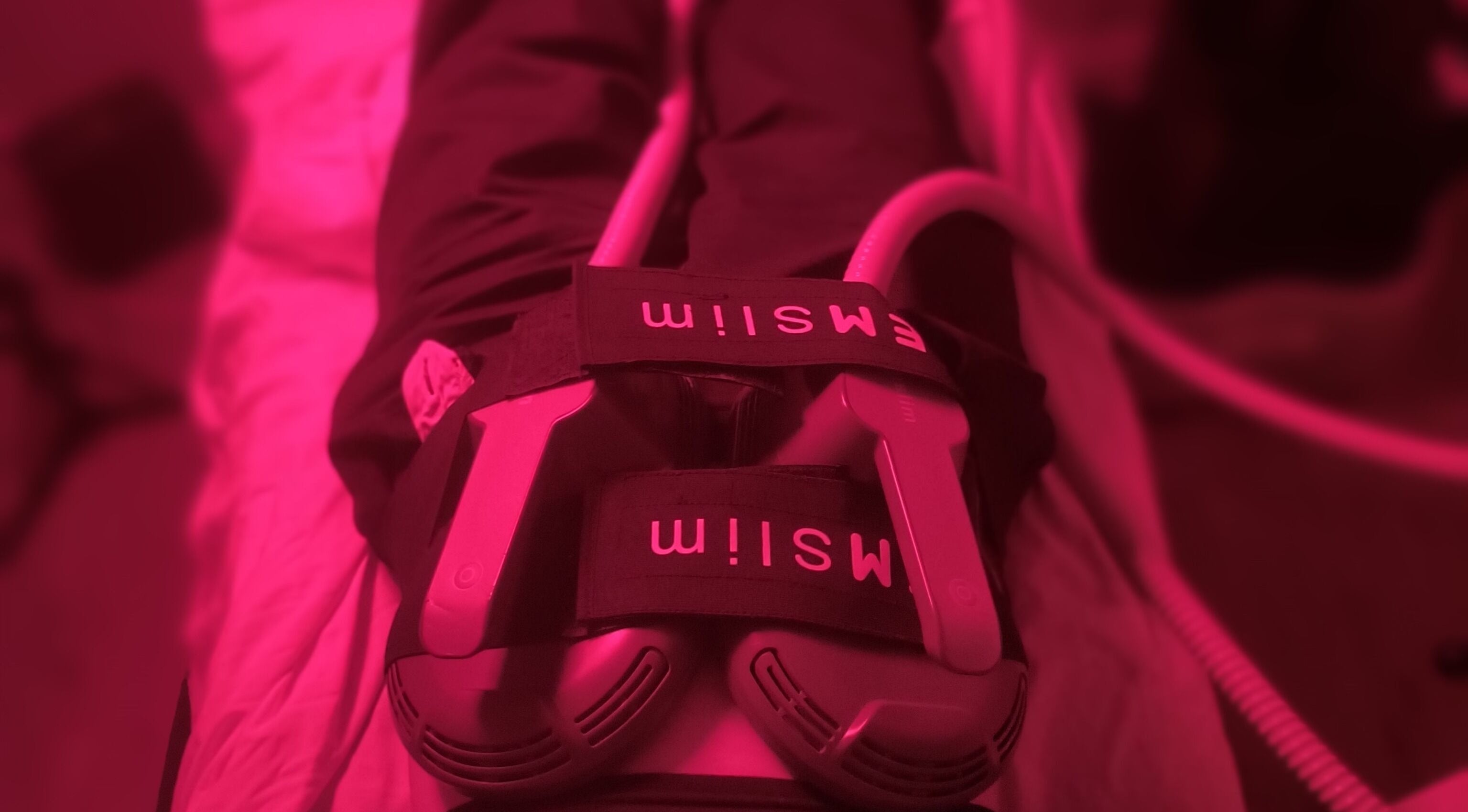 EMS therapy session at Elevation Body Boost, Vancouver, British Columbia, CA, with bright pink lighting.