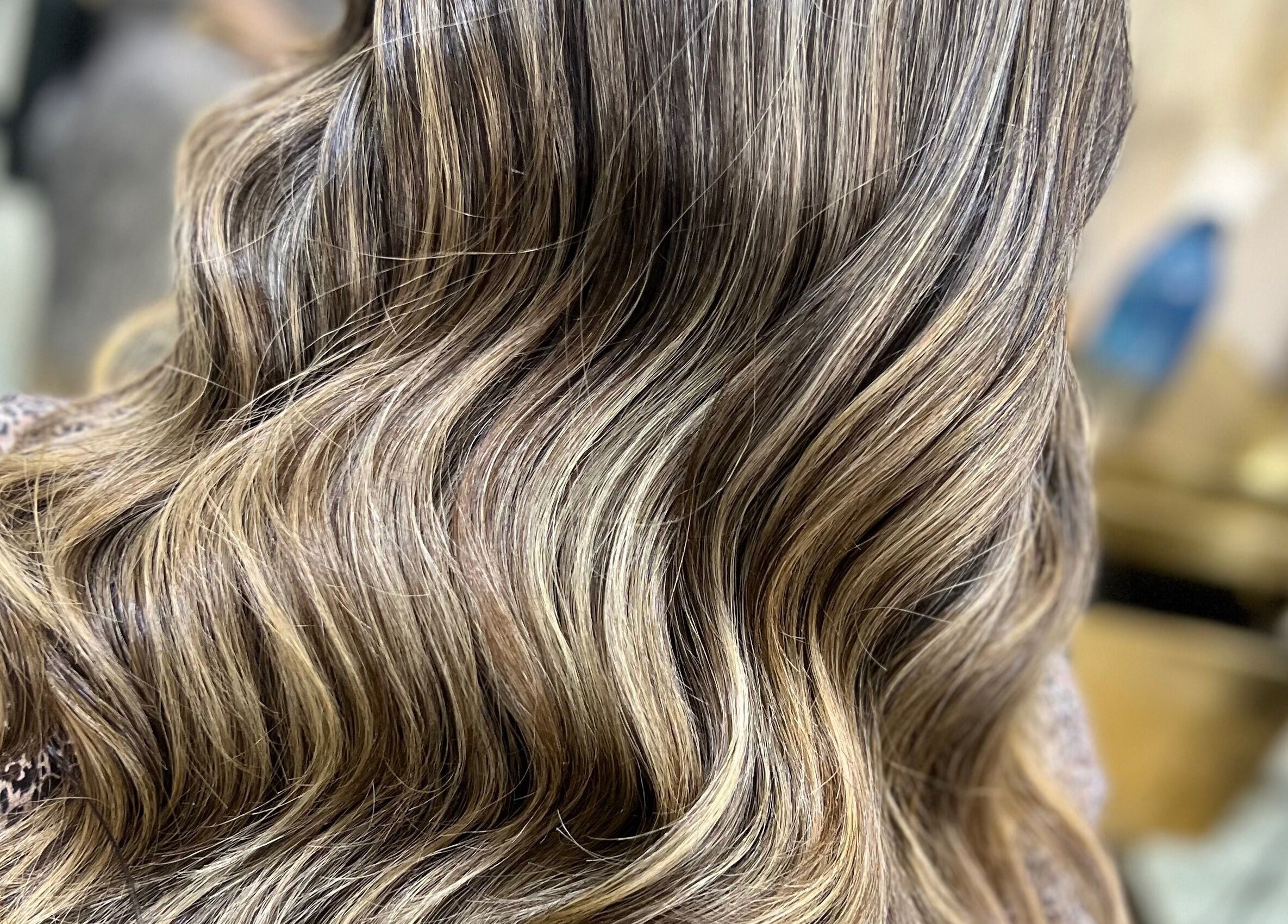 Elegant wavy hair styled at ALYSSA BEAUTY SALON, Seremban, Negeri Sembilan, MY, showcasing soft highlights.