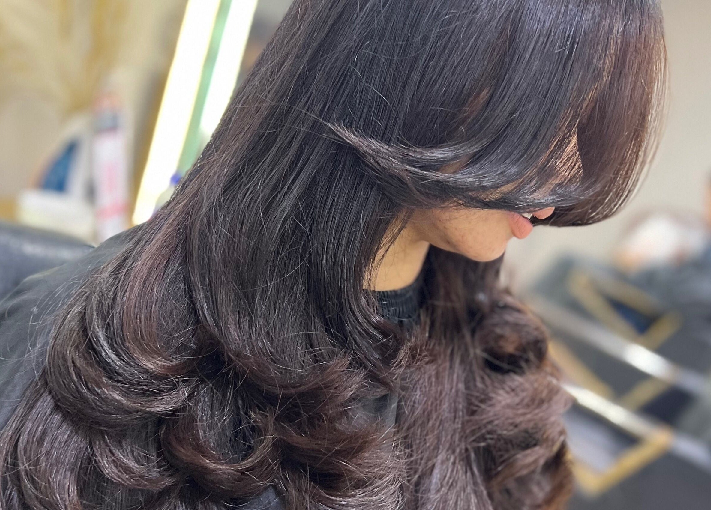 Elegant hairstyle showcasing flowing curls at ALYSSA BEAUTY SALON, Seremban, Negeri Sembilan, MY.