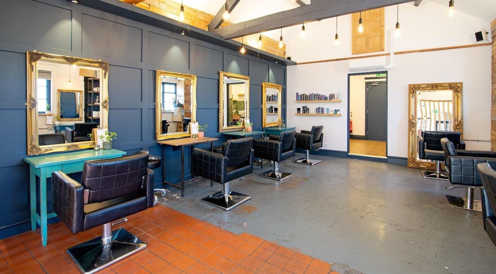 Chic interior of M A Hair in Rothley, England, GB, featuring stylish mirrors and comfortable chairs.