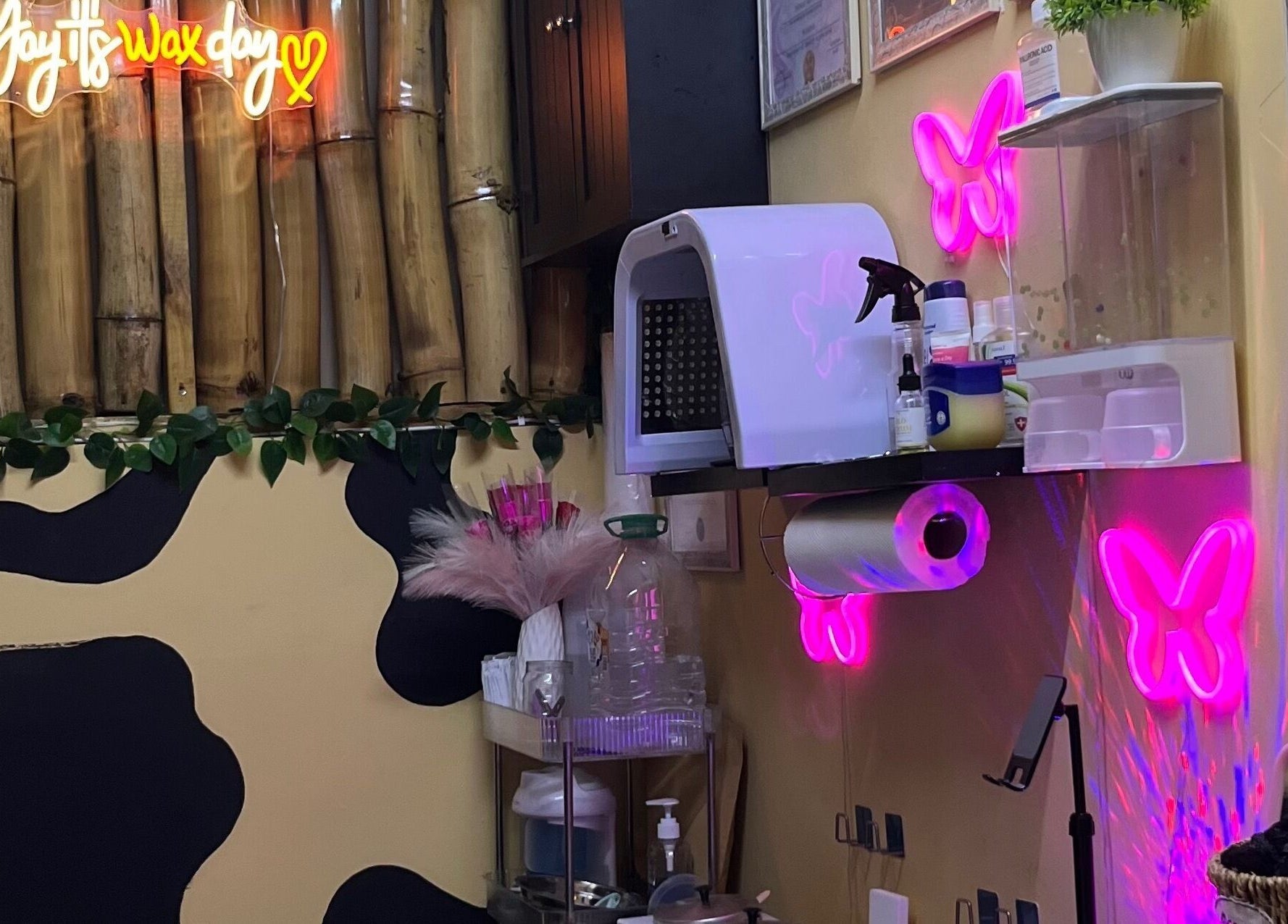 Cozy beauty room at Tru Skin Studio, Lucea, Hanover Parish, JM, featuring neon lights and bamboo decor.