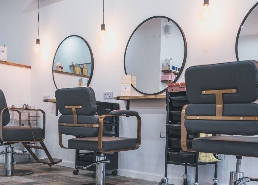 Modern salon chairs at Hayden Hair Studio in Bletchley, England, GB, showcasing stylish interior design.