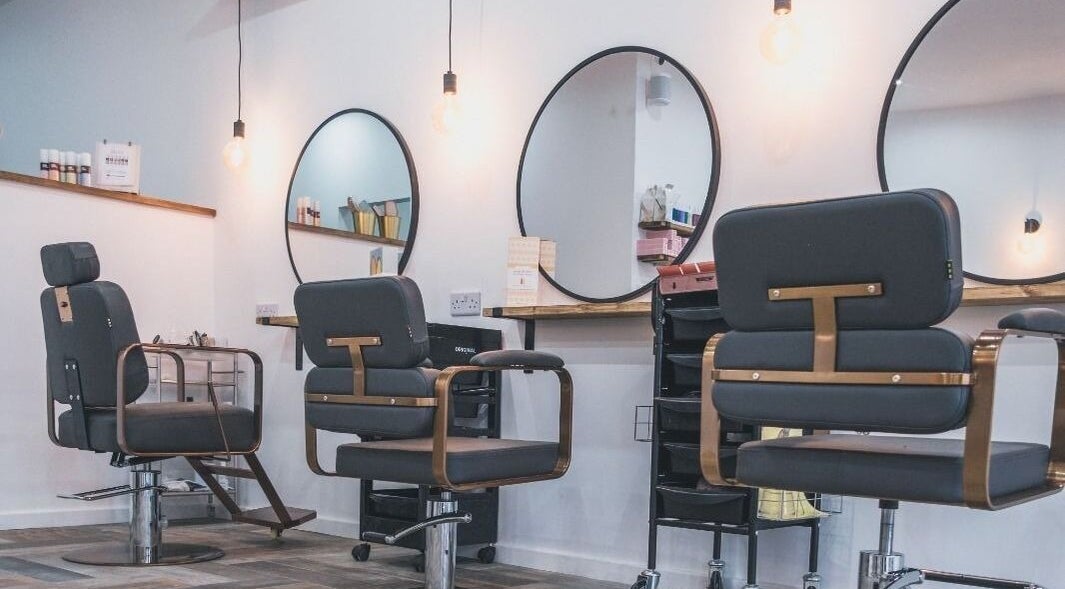 Modern salon chairs at Hayden Hair Studio in Bletchley, England, GB, showcasing stylish interior design.