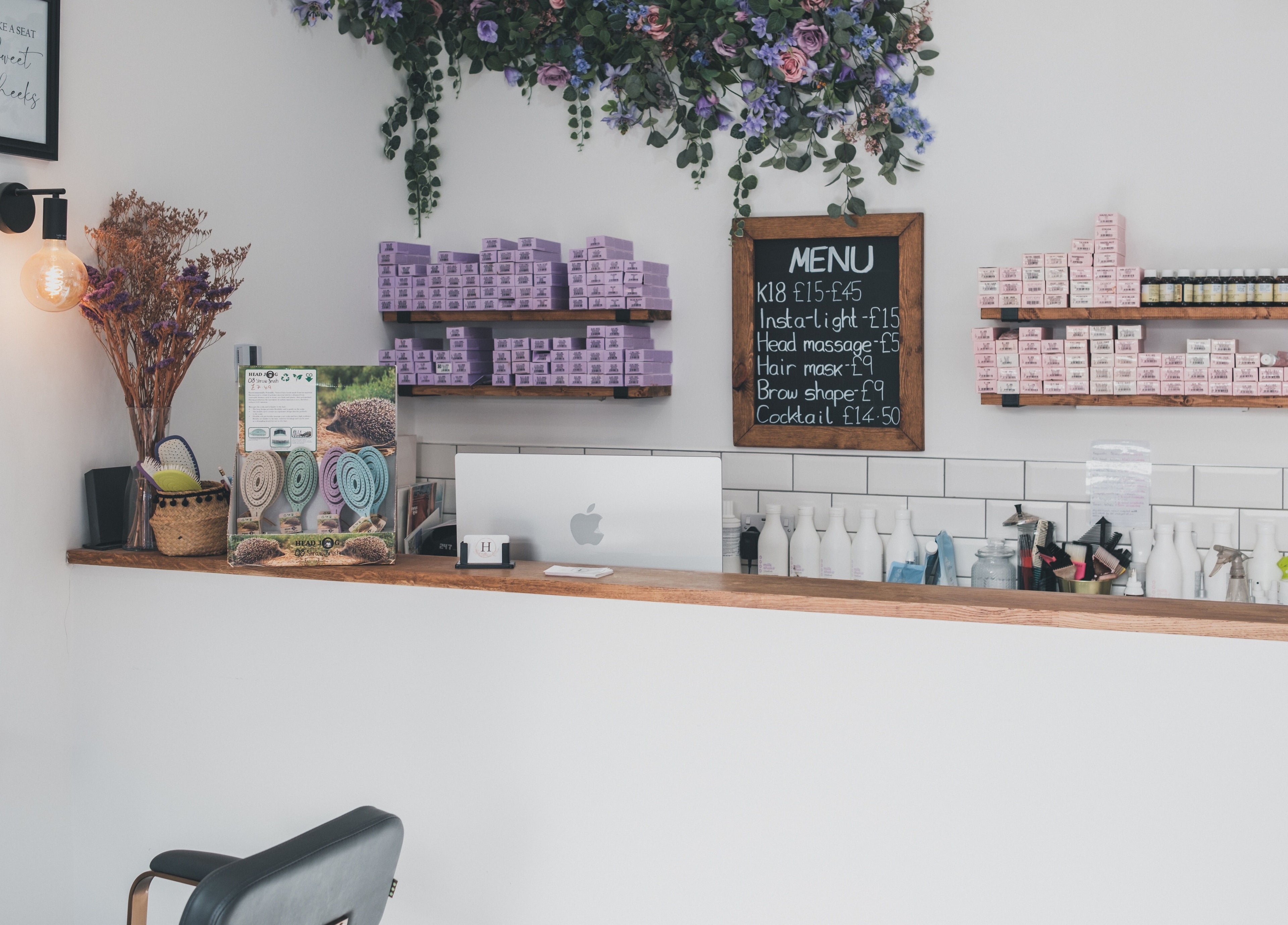 Hayden Hair Studio reception area with elegant decor and product display in Bletchley, England, GB.