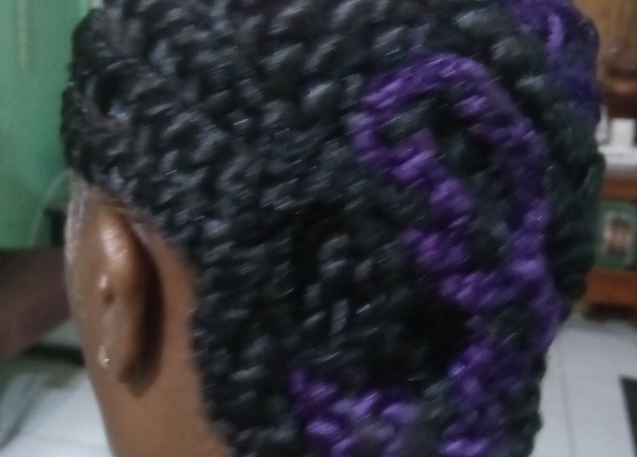 Intricate braided hairstyle with purple highlights at Origins Natural Beauty, Nassau, New Providence, BS.