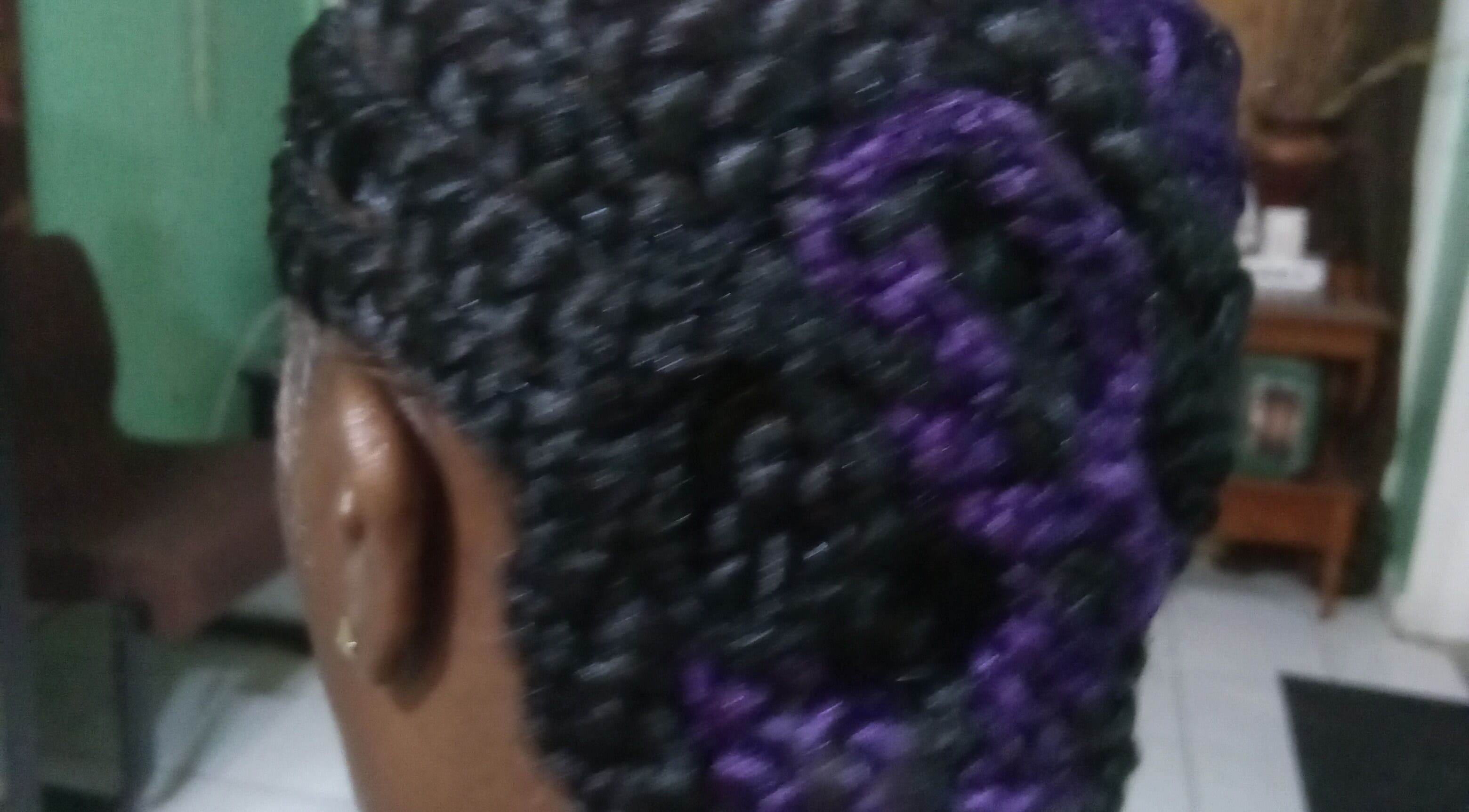 Intricate braided hairstyle with purple highlights at Origins Natural Beauty, Nassau, New Providence, BS.