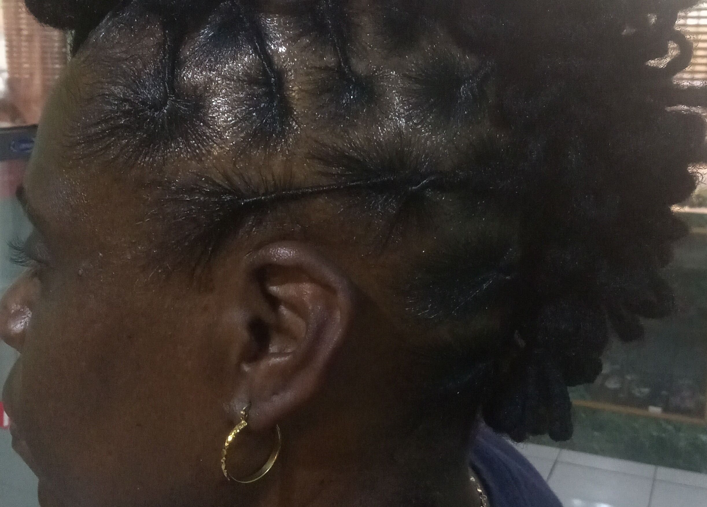 Close-up of intricately styled locs at Origins Natural Beauty, Nassau, New Providence, BS.