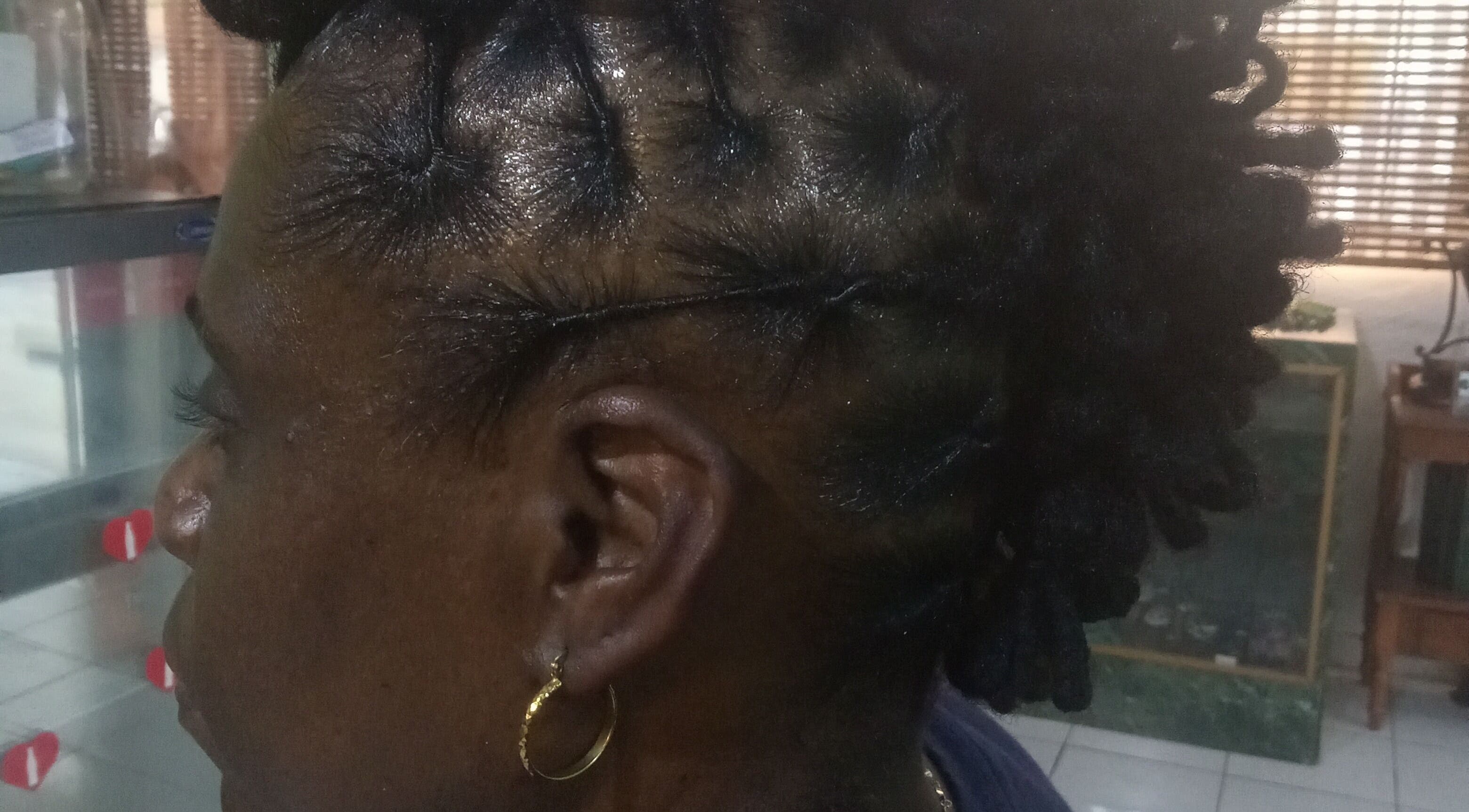 Close-up of intricately styled locs at Origins Natural Beauty, Nassau, New Providence, BS.
