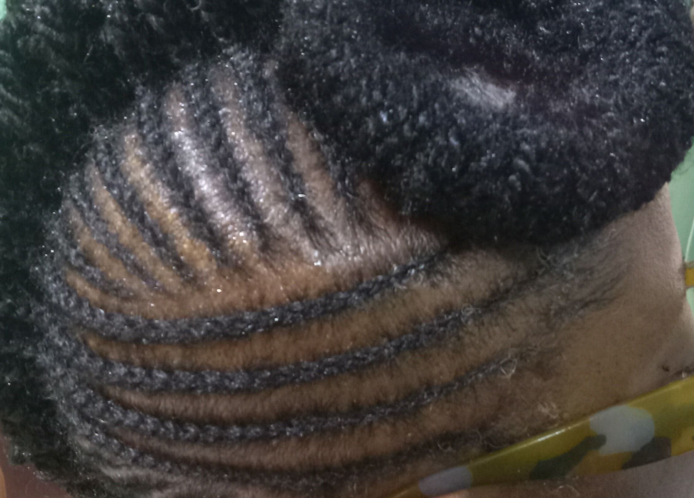 Intricate braided hairstyle at Origins Natural Beauty, Nassau, New Providence, BS, showcasing artistic styling.