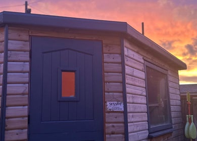 Eunoia holistic beauty cabin at sunset in Hull, England, GB. Cozy ambiance reflecting wellness and tranquility.