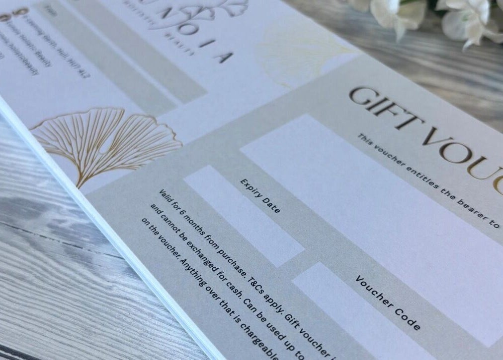 Gift voucher from Eunoia holistic beauty, Hull, England, GB, on a wooden surface.