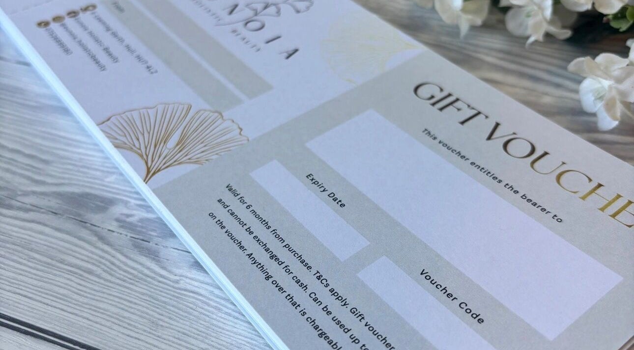 Gift voucher from Eunoia holistic beauty, Hull, England, GB, on a wooden surface.