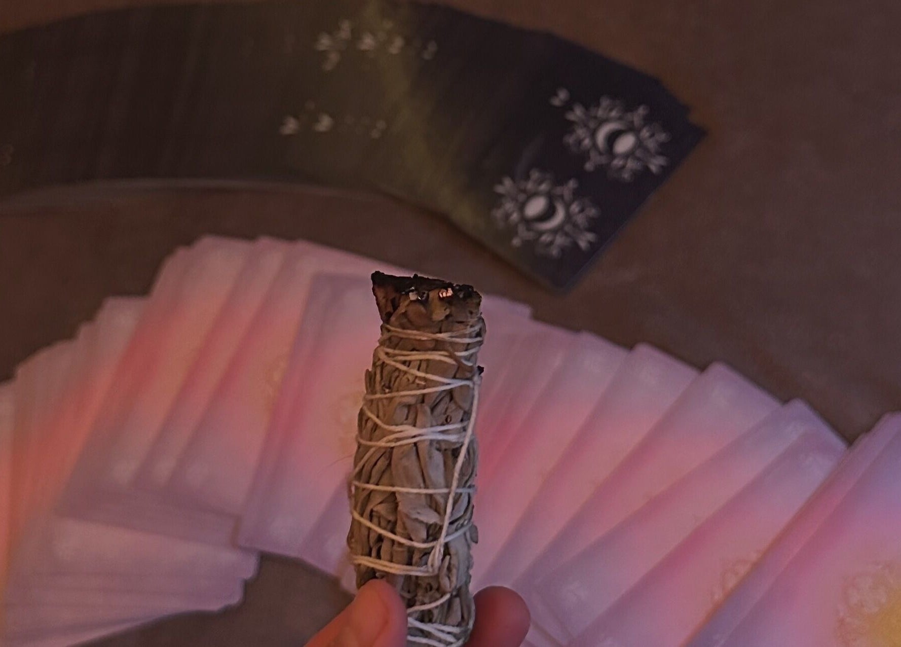Sage smudge stick and tarot cards at Eunoia holistic beauty, Hull, England, GB for spiritual wellness.