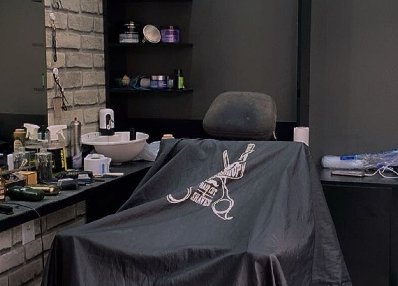 Interior sofisticado da Barbearia Malle em São Paulo, SP. Ambiente moderno com cadeira e produtos de beleza.