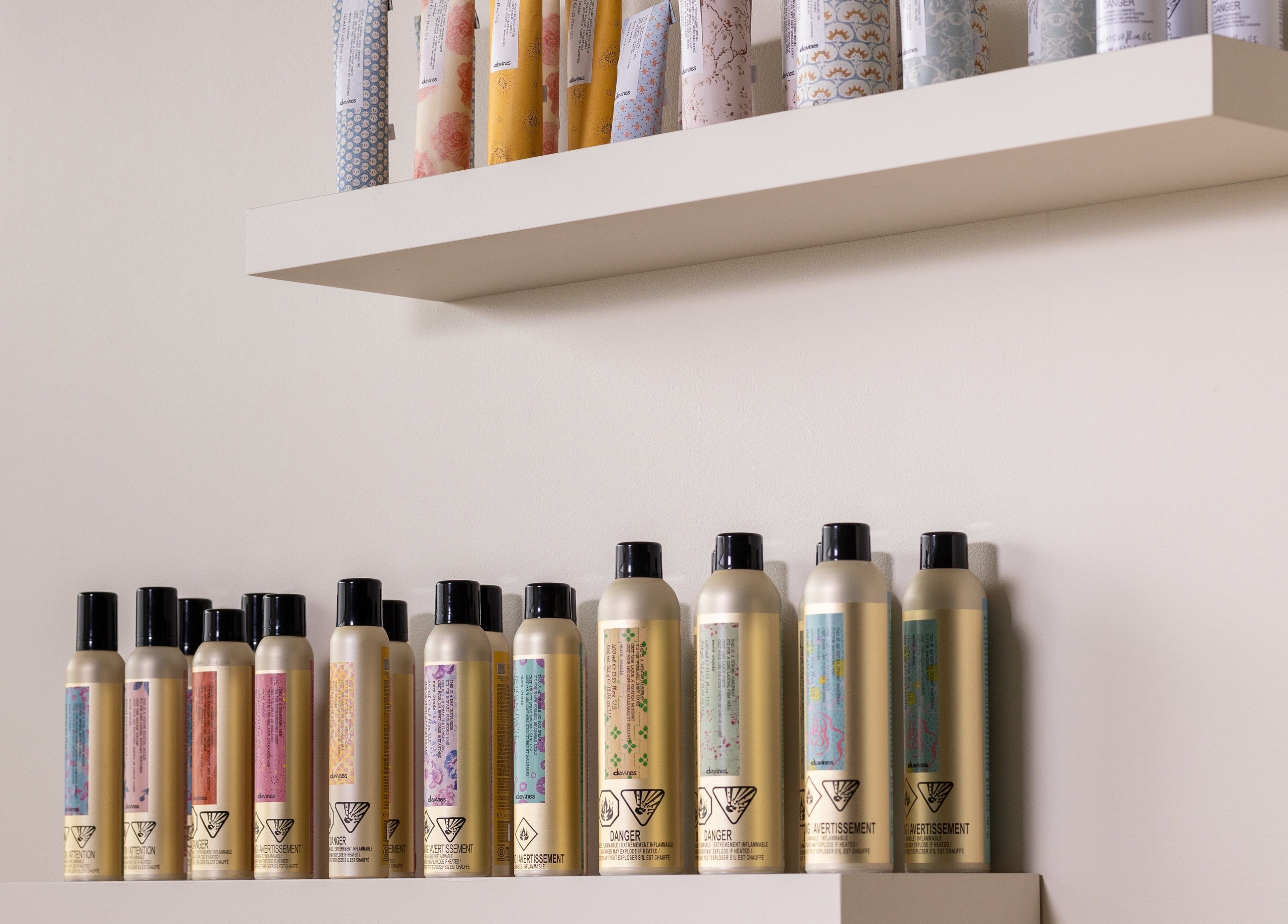 Salon Goldn in Laval, Québec, CA showcases diverse hair care products on sleek shelves.