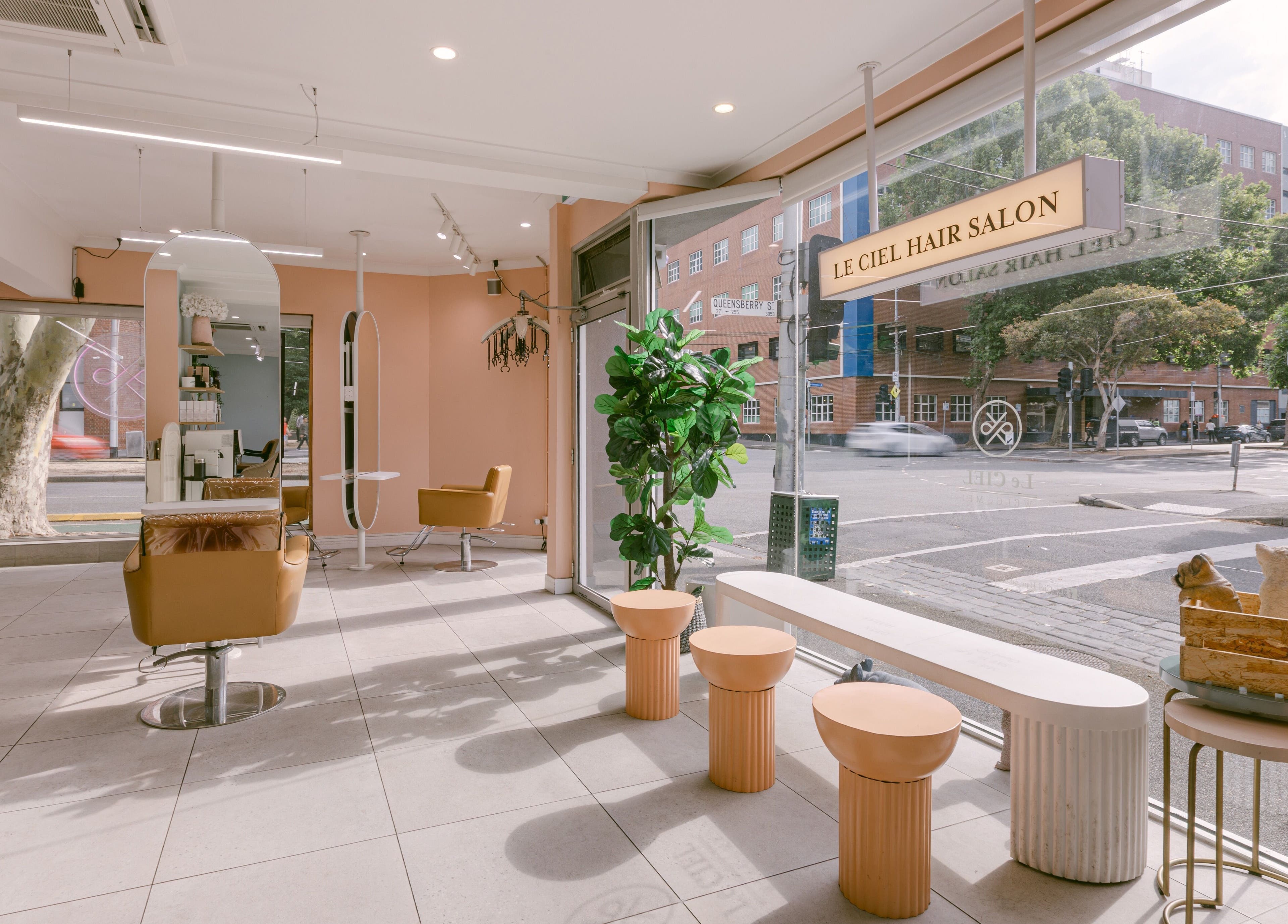 Modern interior of Le Ciel Salon in Carlton, Victoria, AU featuring stylish seating and large windows.