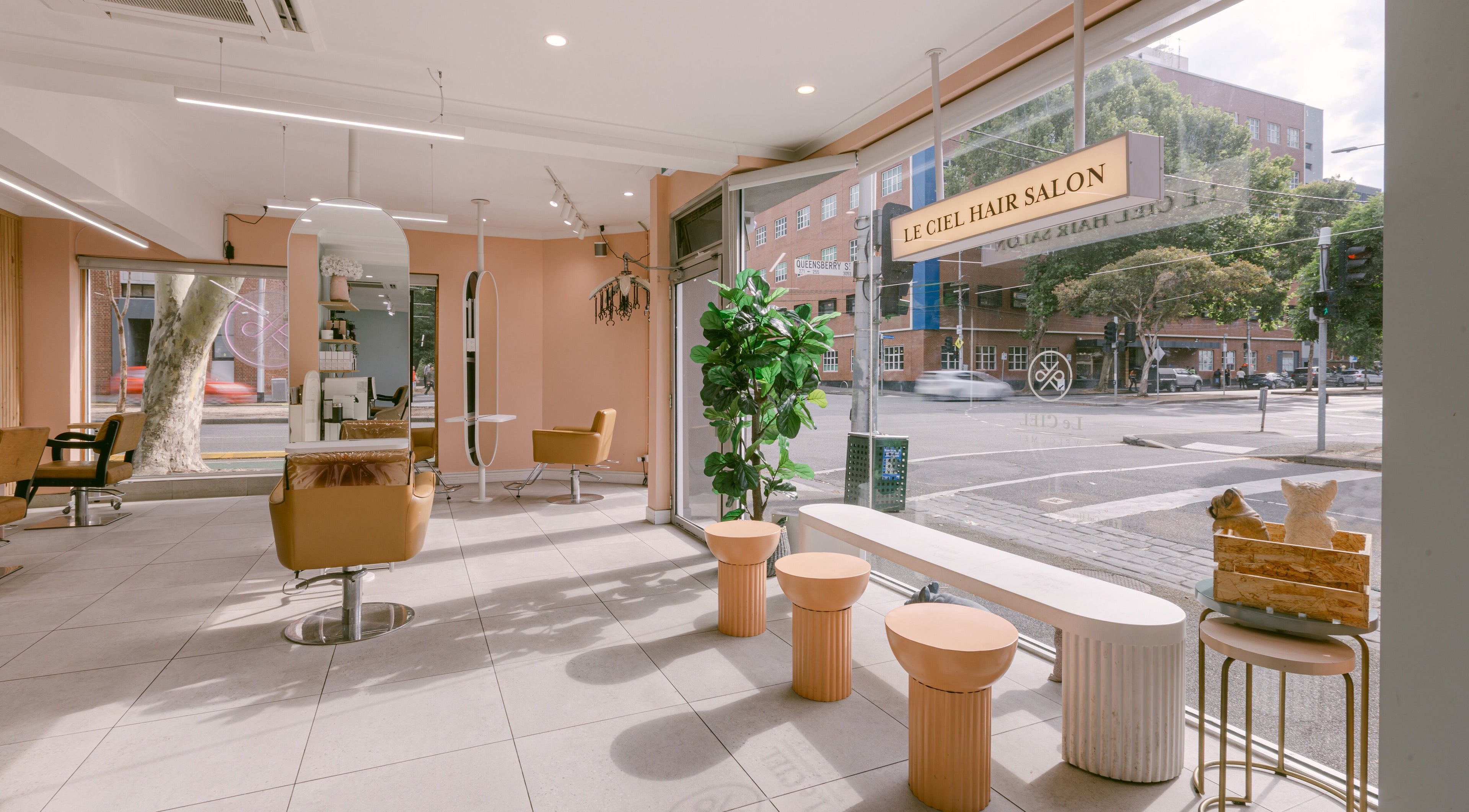 Modern interior of Le Ciel Salon in Carlton, Victoria, AU featuring stylish seating and large windows.