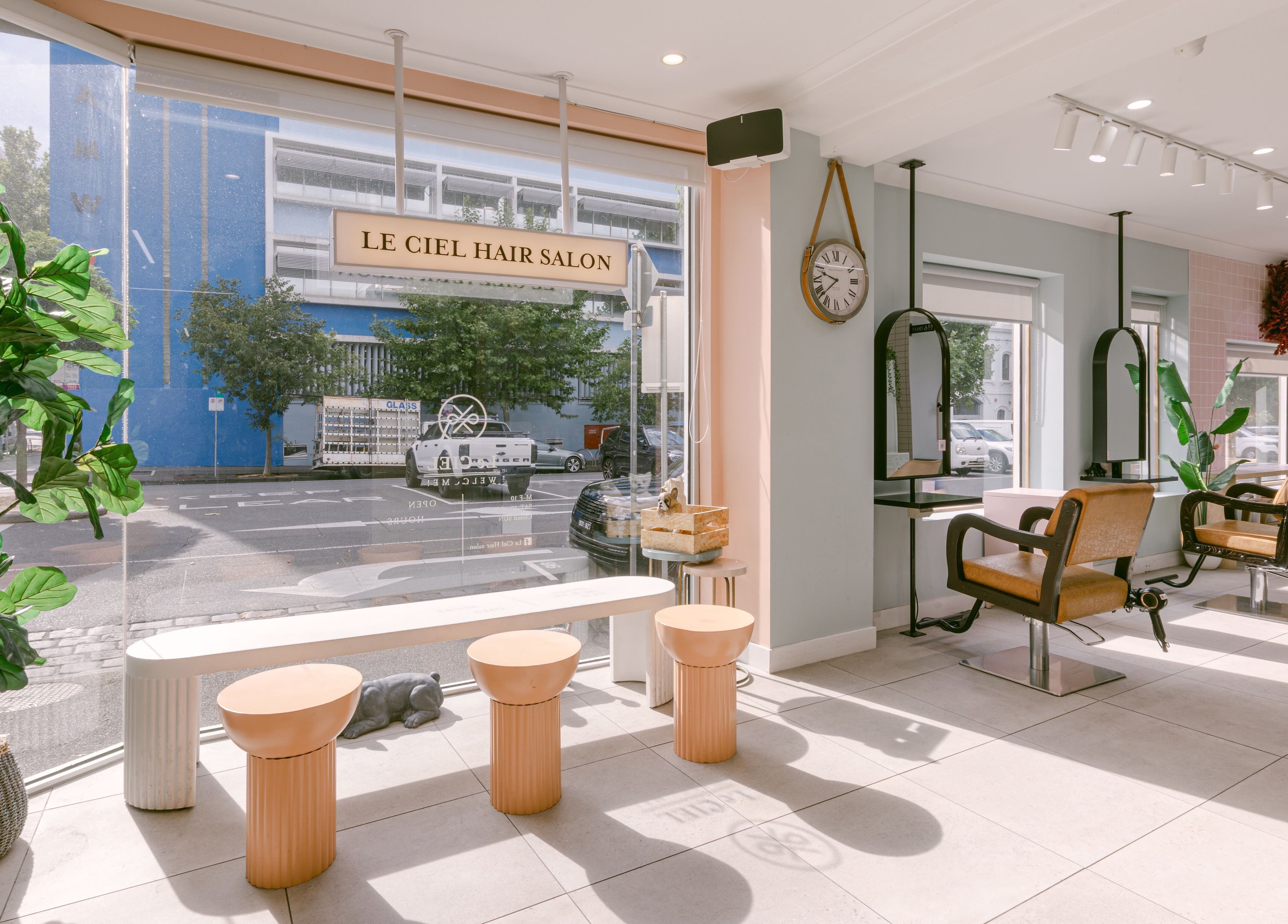 Modern seating area at Le Ciel Salon with stylish chairs and bright decor, located in Carlton, Victoria, AU.