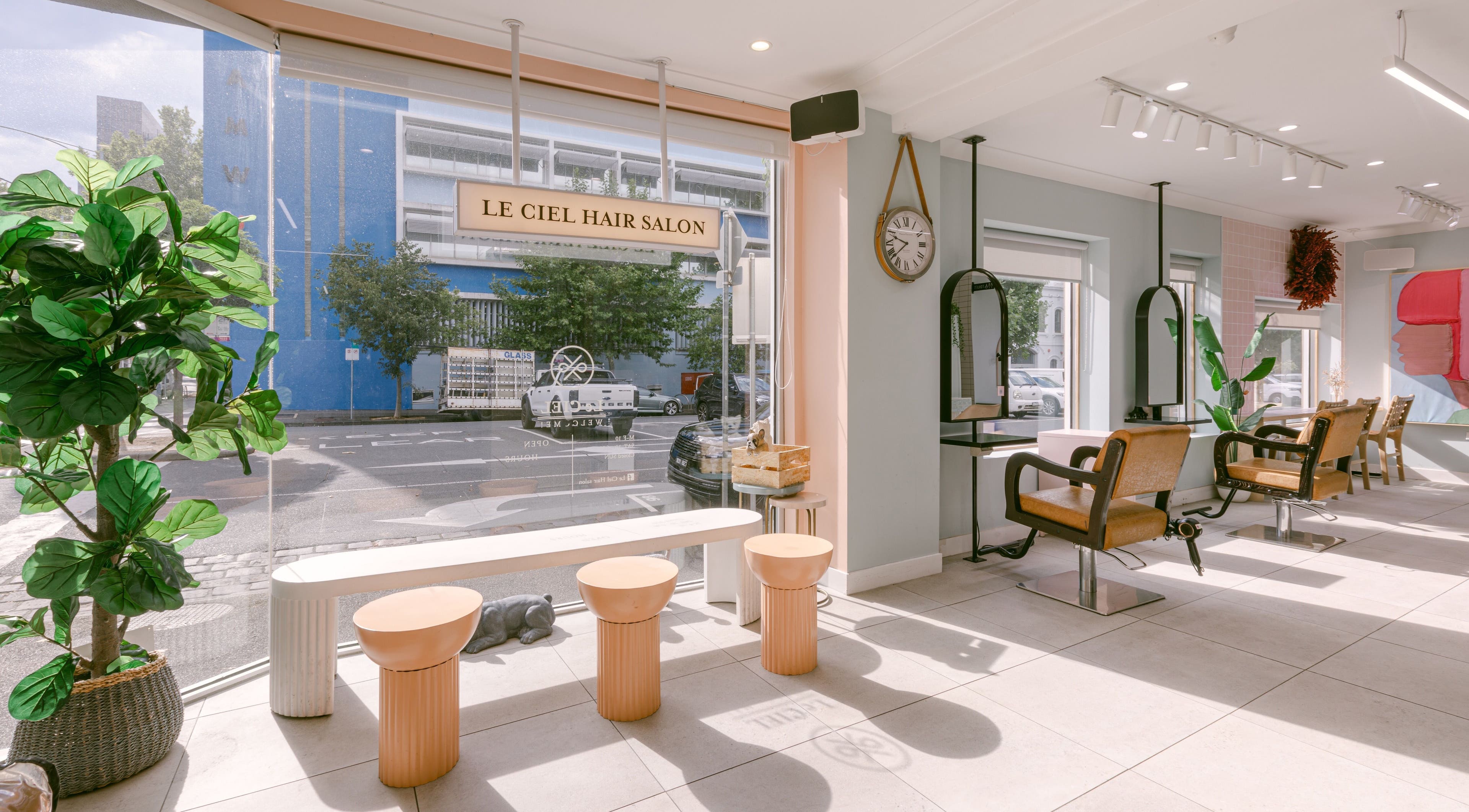Modern seating area at Le Ciel Salon with stylish chairs and bright decor, located in Carlton, Victoria, AU.