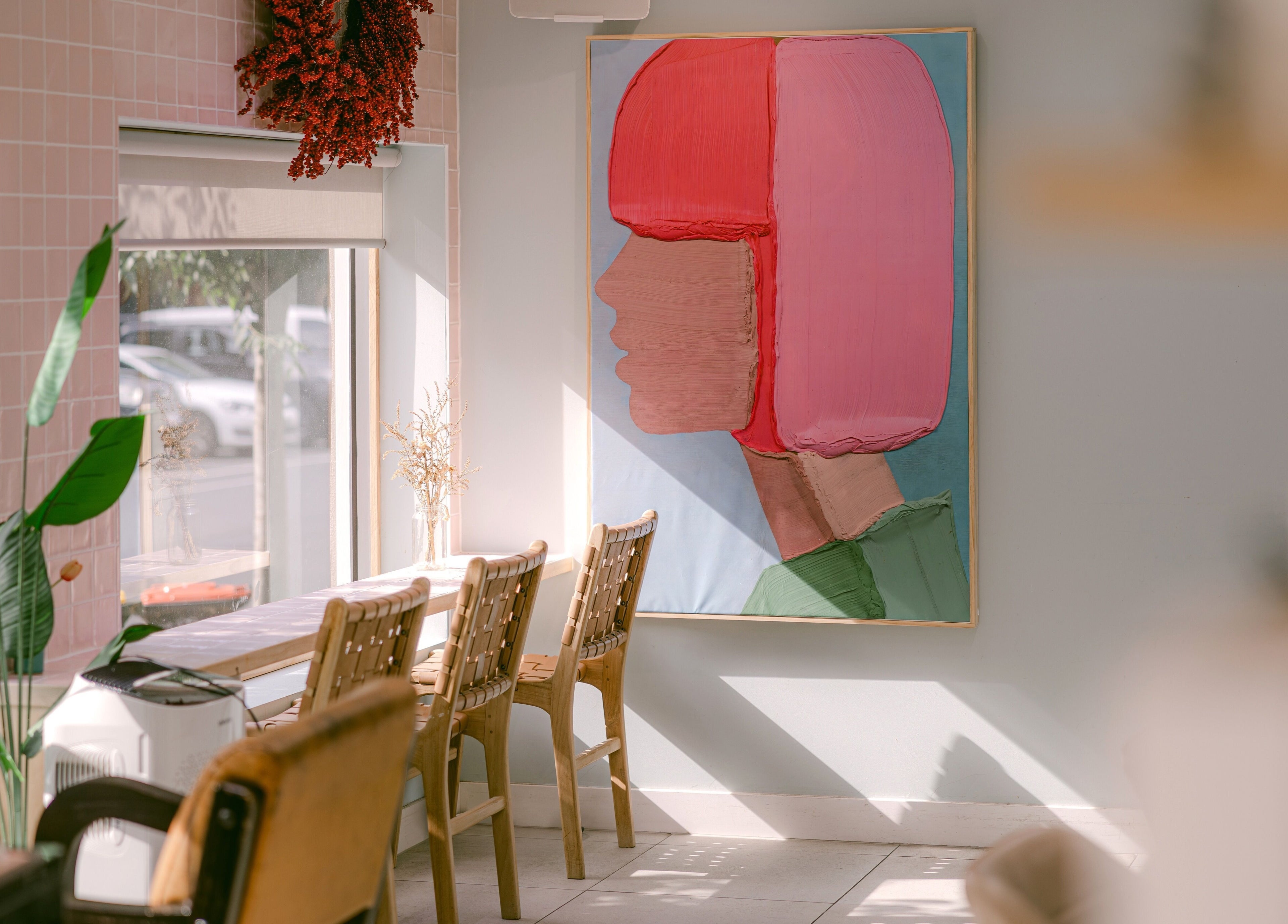 Chic interior with art at Le Ciel Salon, Carlton, Victoria, AU. Sunny space with stylish decor.