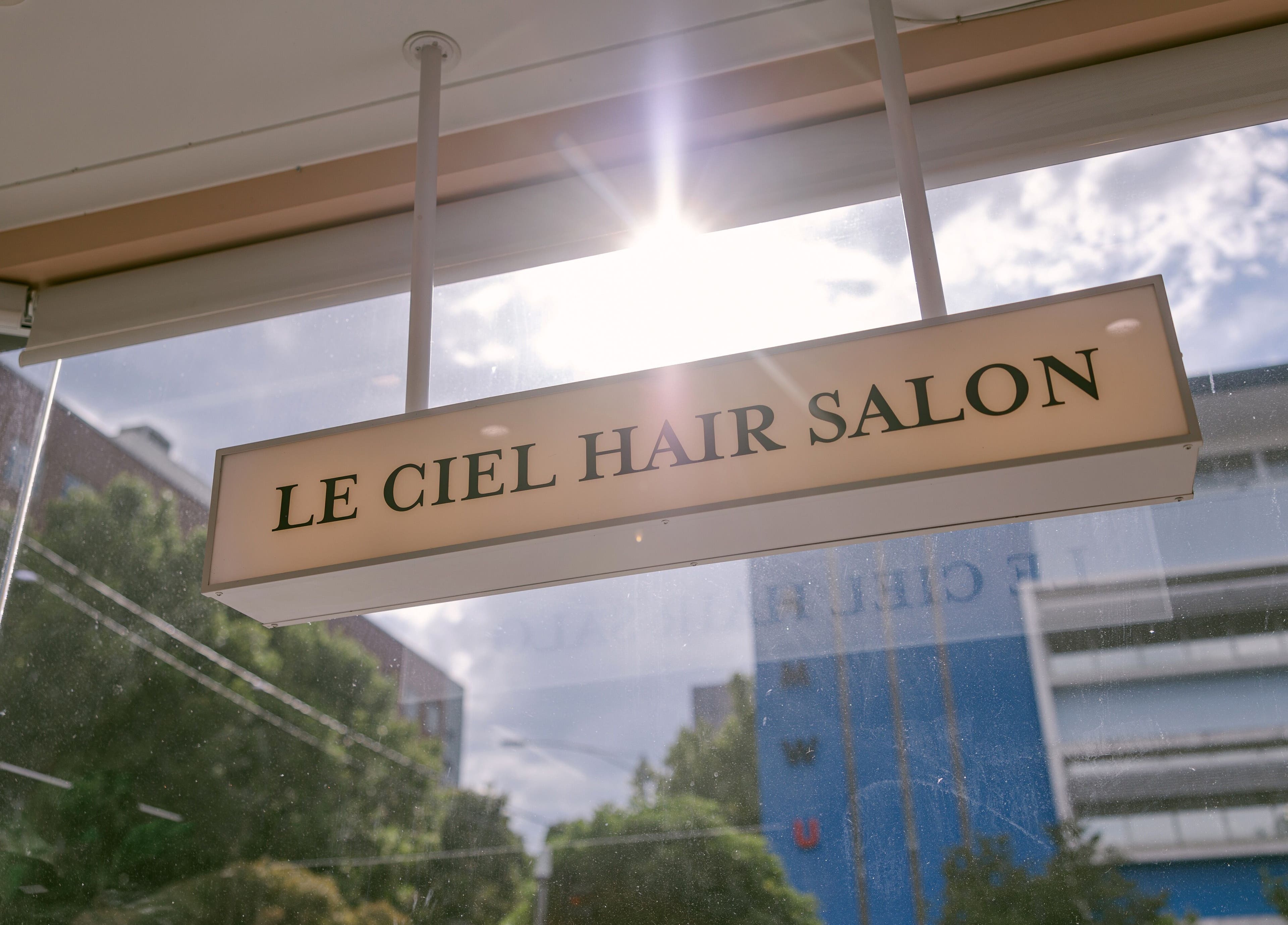 Le Ciel Salon sign at Carlton, Victoria, AU, with sunlight streaming through the window.