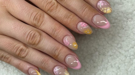 Elegant floral nail art at Raw Claws Beauty in Lismore, New South Wales, AU showcasing pink and yellow designs.