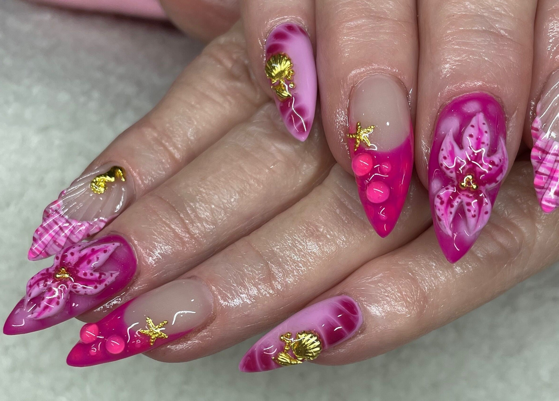 Detailed nail art design at Raw Claws Beauty in Lismore, New South Wales, AU showcases vibrant pink and gold accents.