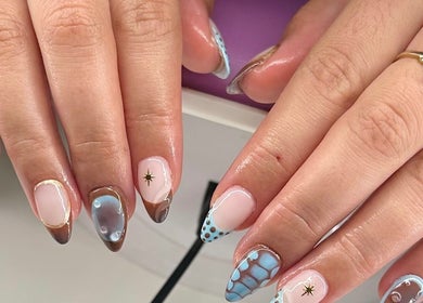 Stylish nail designs at KCNailStudio in Logan Reserve, Queensland, AU showcase intricate blue and brown patterns.