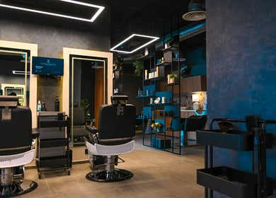 Interior of Two's Barbershop, Riyadh with stylish decor and sleek barber chairs.