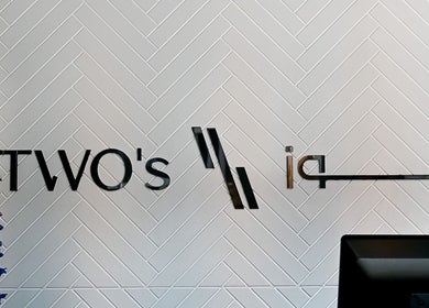 Two's Barbershop logo on a stylish patterned wall in Riyadh, Riyadh Province, SA.