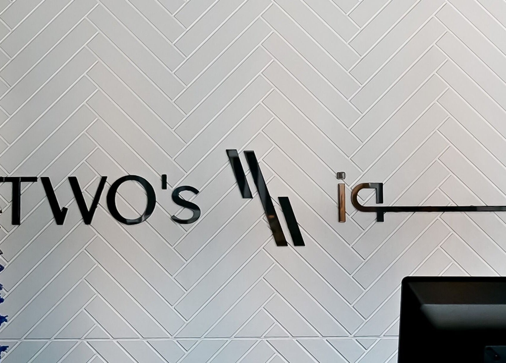 Two's Barbershop logo on a stylish patterned wall in Riyadh, Riyadh Province, SA.