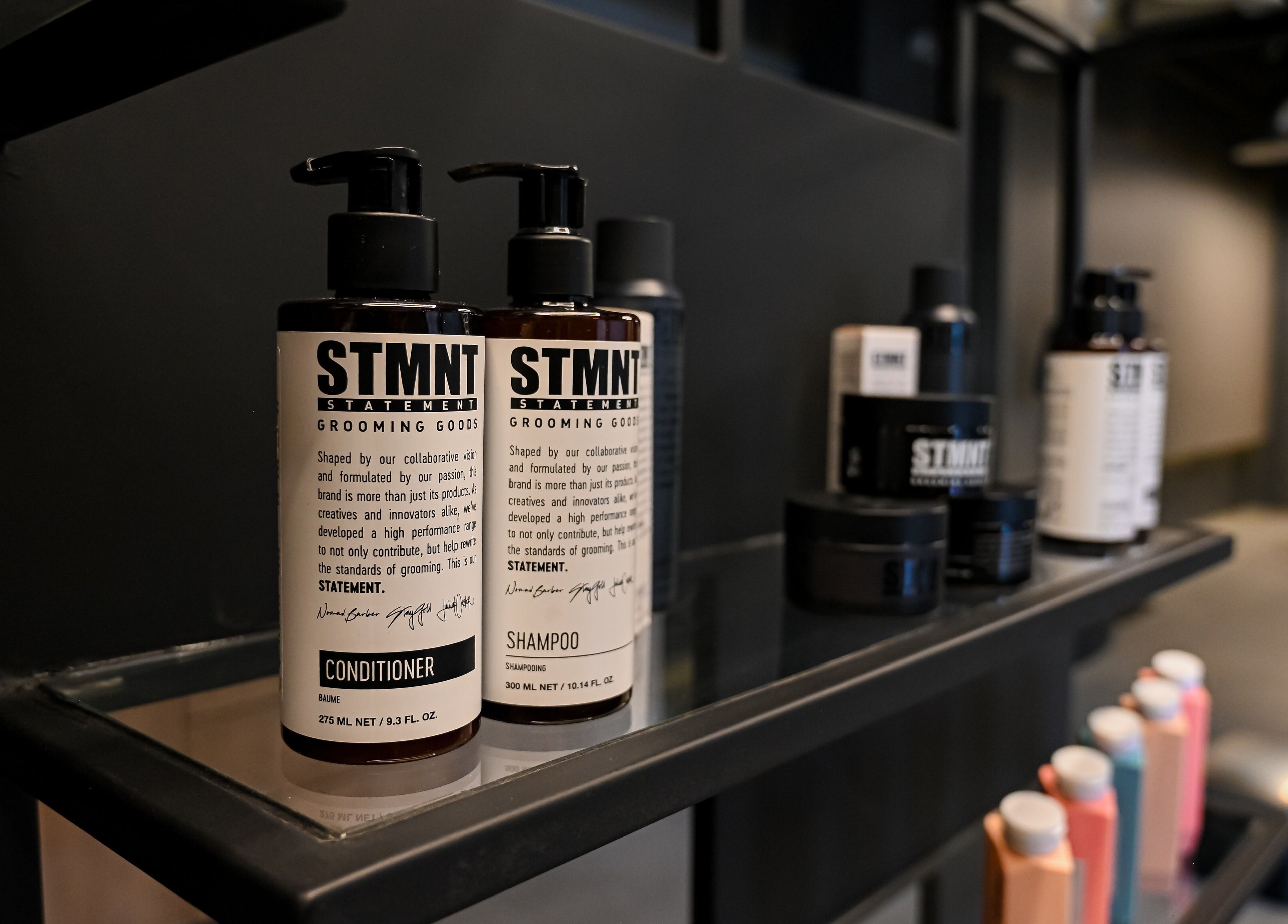 Shampoo and conditioner display at Two's Barbershop, Riyadh, Riyadh Province, SA offering luxury grooming products.